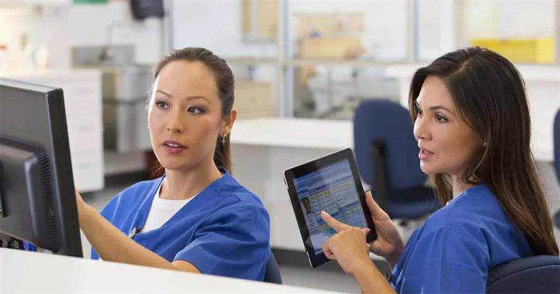 Nurses talking and pointing at device screens