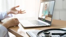 clinician hands and laptop open to a telehealth call