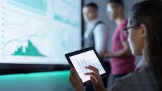 Businessperson viewing graphs on a tablet