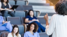 Alt text: A university instructor lecturing college students