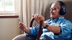 Senior consults with physician via telehealth with smartphone