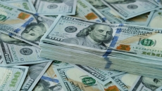 Stack of $100 U.S. dollars on loose bills