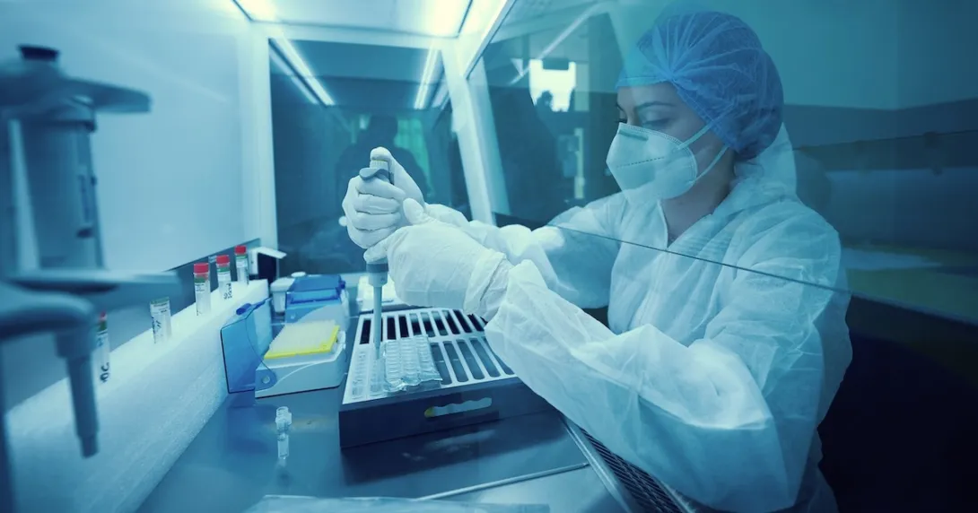 Lab worker in full protective gear