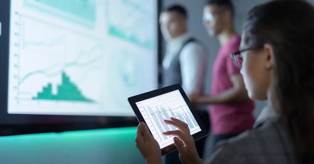 Businessperson viewing graphs on a tablet