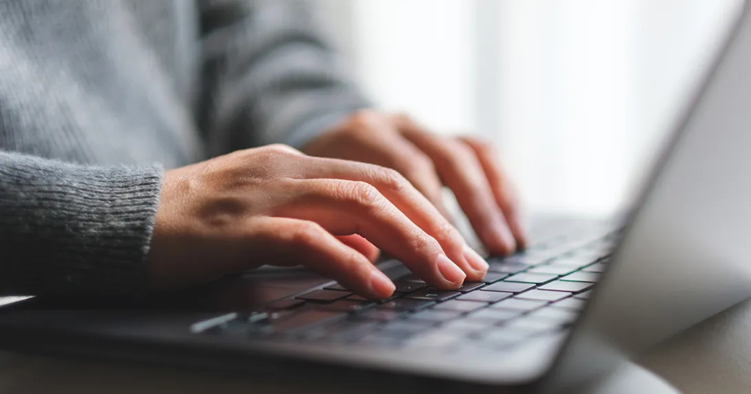 woman's hands on laptop