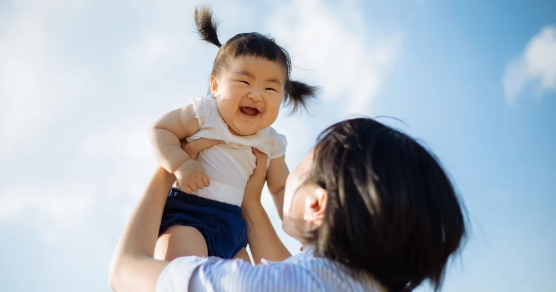 Person holding child in the air