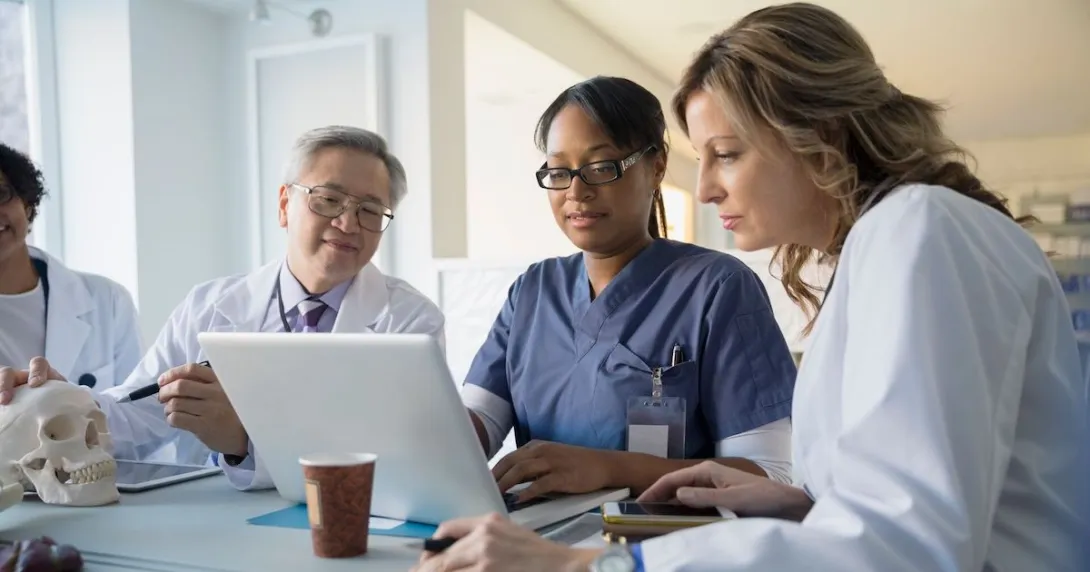 Doctors review information on a laptop